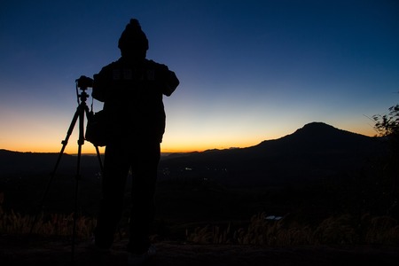 Phetchabun, Thailand - January, 21, 2017 : Silhouettes of Tourists come to see and photograph the sunrise in the morning at Phu Lom Lo, Phu Hin Rong Kla National Park, Phetchabun, Thailand.のeditorial素材