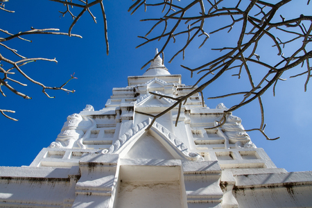 Saraburi, Thailand - January, 22, 2017 : White pagoda and the anciect architectural temple building with blue sky in Thailand. Phrabuddhabat temple, Saraburi province.のeditorial素材