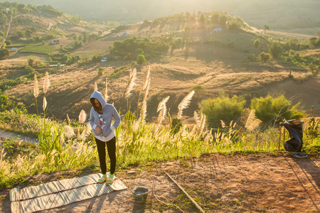 Phetchabun, Thailand - January, 22, 2017 : Tourist Camping on the hill with sunshine in the sunrise at Takhian Ngoa Mountain Phetchabun, Thailand.Natural summer landscape.のeditorial素材