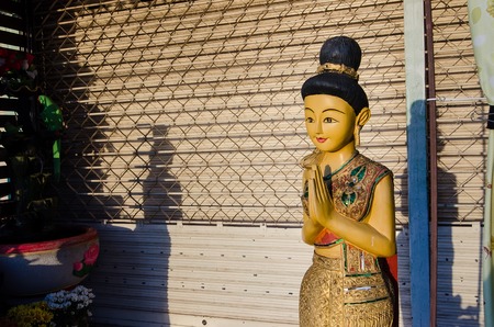 Wooden woman Standing Hello Thailand "Sawasdee".の写真素材