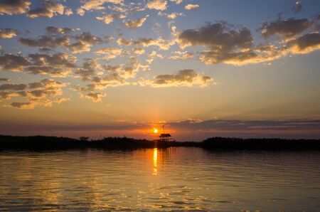 Fantastic landscape, multicolor sky over the lake. majestic sunrise. use as background. color in nature. beautiful in nature. series with many color variations.The reflection of the sky in waterの写真素材
