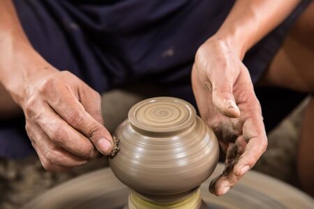 Nonthaburi, Thailand - February, 22, 2017 : Hand of potter man traditional pottery making shaping a bowl on the spinning by clay at Koh Kret Nonthaburi, Thailandのeditorial素材