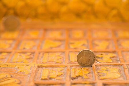 Baht coin on image of buddha's footprintの写真素材