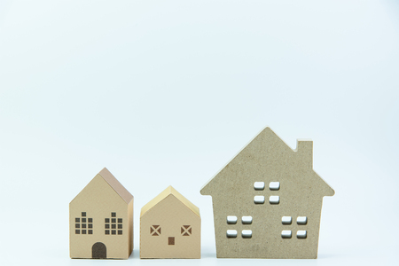 Wooden house toy and paper house isolated on white background with copy space.Real estate concept, New house concept, Finance loan business conceptの写真素材