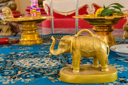 Small gold elephant for raise cast lots in temple Thailandの写真素材