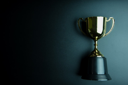 Golden trophy isolated on black background with copy space.Concept winnerの写真素材