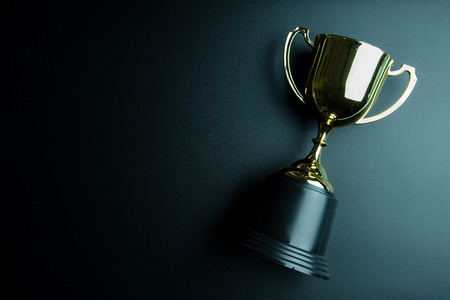 Golden trophy isolated on black background with copy space.Concept winnerの写真素材