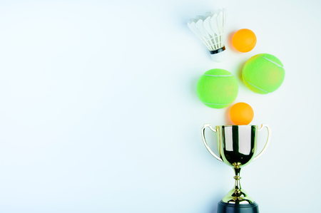 Golden trophy, Shuttlecock, Ping pong ball and Tennis ball isolated on white background with copy space.Concept winner of the sportの写真素材