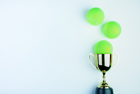 Golden trophy and Tennis ball isolated on white background with copy space.Concept winner of the sportの写真素材