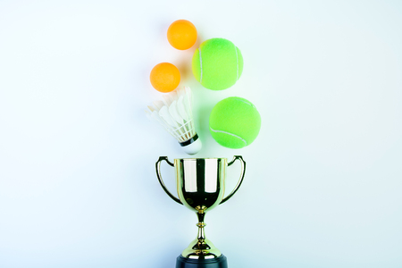 Golden trophy, Shuttlecock, Ping pong ball and Tennis ball isolated on white background with copy space.Concept winner of the sportの写真素材