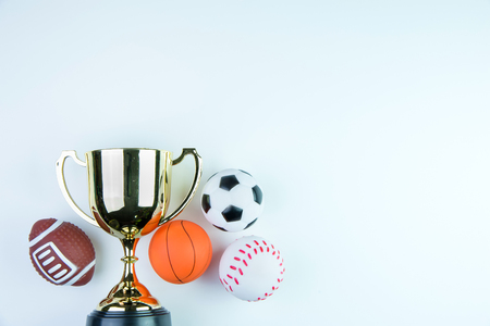 Golden trophy, Football toy, Baseball toy, Basketball toy and Rugby toy isolated on white background with copy space.Concept winner of the sportの写真素材