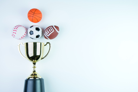 Golden trophy, Football toy, Baseball toy, Basketball toy and Rugby toy isolated on white background with copy space.Concept winner of the sportの写真素材