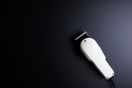 White electric clippers barber on black background. Hairdresser salon concept, Hairdressing Set. Haircut accessories. Copy space image, flat layの写真素材