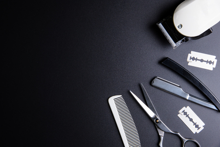 Razor, Stylish Professional Barber Scissors, White comb and White electric clippers on black background. Hairdresser salon concept, Hairdressing Set. Haircut accessories. Copy space image, flat layの写真素材