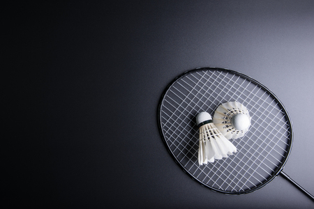 Two shuttlecocks and badminton racket on black background.Sport concept, Copy space image for your textの写真素材