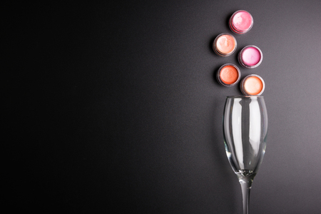 Lipstick cartridges and Wine glass isolated on black background, Cosmetics concept, Makeup concept, Copy space image for your text, Flat layの写真素材