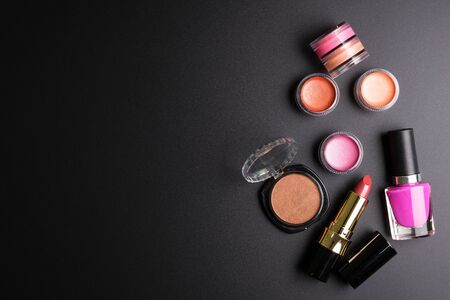 Red lipstick, Nail polisher and Makeup powder isolated on black background, Cosmetics concept, Makeup concept, Copy space image for your text, Flat layの写真素材