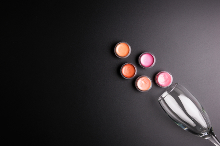 Lipstick cartridges and Wine glass isolated on black background, Cosmetics concept, Makeup concept, Copy space image for your text, Flat layの写真素材
