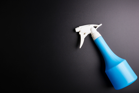 Blue spray bottle isolated on black background, Cosmetics concept, Makeup concept, Copy space image for your textの写真素材