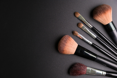 Set of flat top view of various professional female cosmetics brushes for makeup isolated on black background, Cosmetics concept, Makeup concept, Copy space image for your text, Flat layの写真素材