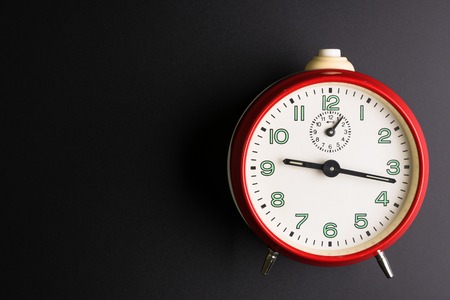 Red alarm clock isolated on black background, Time concept, Rush hour concept, Copy space image for your text, Flat layの写真素材
