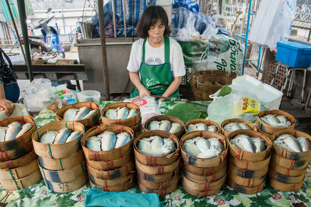 Bangkok, Thailand - April, 09, 2017 : Unidentified woman seller steamed mackerels fish in Taling Chan Floating Markett at Bangkok, Thailand.のeditorial素材