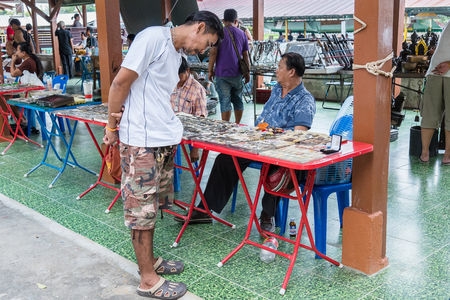 Bangkok, Thailand - April, 09, 2017 : Unidentified man are looking amulets distribution panel in Taling Chan Floating Markett at Bangkok, Thailand.のeditorial素材