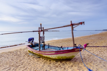 Fishing boats on the beach over cloudy sky at Prachuap Khiri Khan, Thailandの写真素材