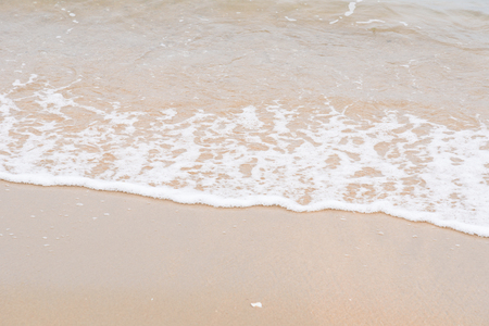 Ocean waves exhausted on the beachの写真素材
