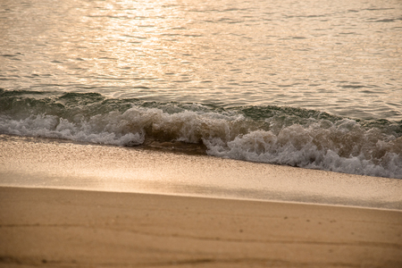 Ocean waves exhausted on the beach in the morning.の写真素材