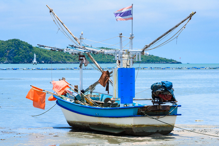 Fishing boats aground on the beach over cloudy sky at Prachuap Khiri Khan, Thailandの写真素材