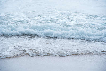 Ocean waves exhausted on the beachの写真素材