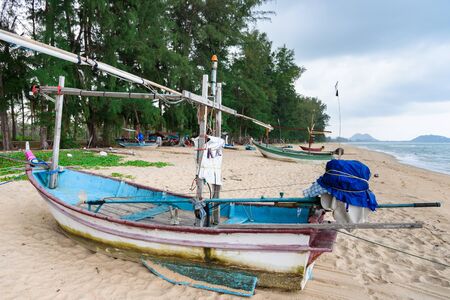 Fishing boats on the beach over cloudy sky at Prachuap Khiri Khan, Thailandの写真素材