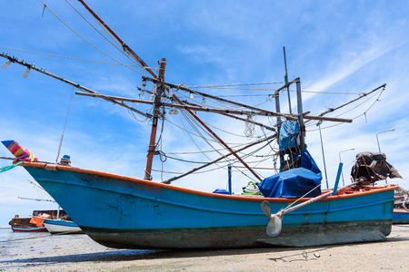 Fishing boats aground on the beach over cloudy sky at Prachuap Khiri Khan, Thailandの写真素材