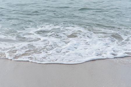 Ocean waves exhausted on the beachの写真素材