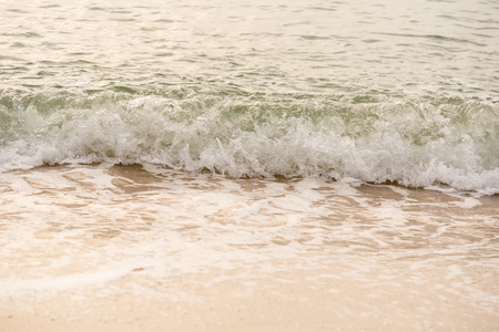 Ocean waves exhausted on the beach in the morning.の写真素材
