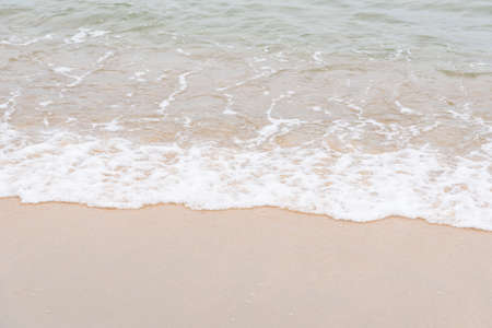 Ocean waves exhausted on the beachの写真素材
