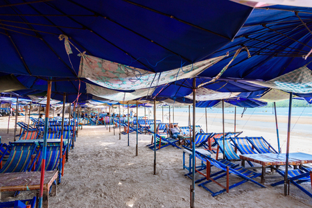 Prachuap Khiri Khan, Thailand - April, 18, 2017 : Sun umbrellas in the warm sandy beach of the tourist at Lime bay in Thongchai Sub district, Bangsapan District, Prachuap Khiri Khan, Thailandのeditorial素材