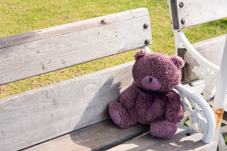 Teddy bears sitting on a wooden chairの写真素材