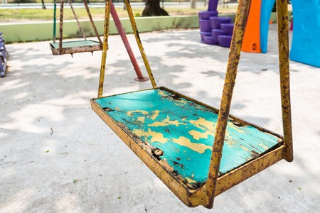 Closeup of colorful swings in playground area at parkの写真素材