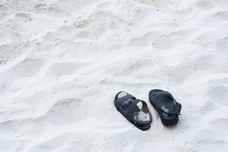 Black shoes on the beachの写真素材