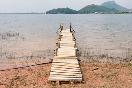 Summer time at the wooden pier in a lake.の写真素材