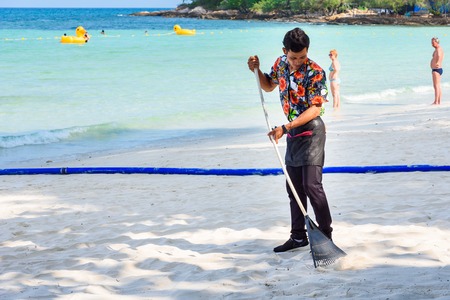 Rayong, Thailand - April, 29, 2017 : Unidentified name Workers are sweeping the leaves on the beach at the Koh Samet island, Rayong, Thailandのeditorial素材