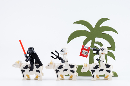 Nonthabure, Thailand - May, 17, 2017 : Lego Darth Vader and Lego stormtrooper riding a cow shooting fake bang isolated on white background.のeditorial素材