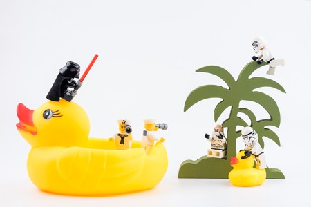 Nonthabure, Thailand - May, 17, 2017 : Lego sailor passenger yellow rubber duck using binoculars looking Lego stormtrooper on the island for to help.のeditorial素材