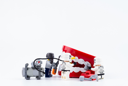 Nonthabure, Thailand - May, 17, 2017 : Lego stormtrooper helping repair the red plastic chattering teeth isolated on white background.のeditorial素材