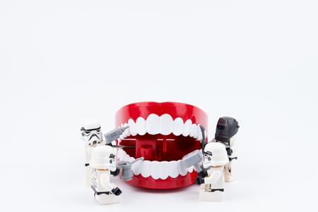 Nonthabure, Thailand - May, 17, 2017 : Lego stormtrooper helping repair the red plastic chattering teeth isolated on white background.のeditorial素材