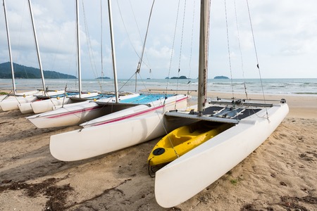 Sail boats on the sandy beach of a tropical islandの写真素材