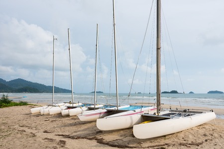 Sail boats on the sandy beach of a tropical islandの写真素材