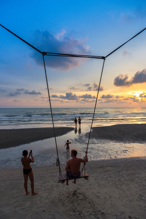 Trat, Thailand - May, 20, 2017 : Unidentified name Father and baby sit on a swing watching the sunset on the beach at Klong Prao Resort in Prao Beach Koh Chang island Trat, Thailand.Concept familyのeditorial素材